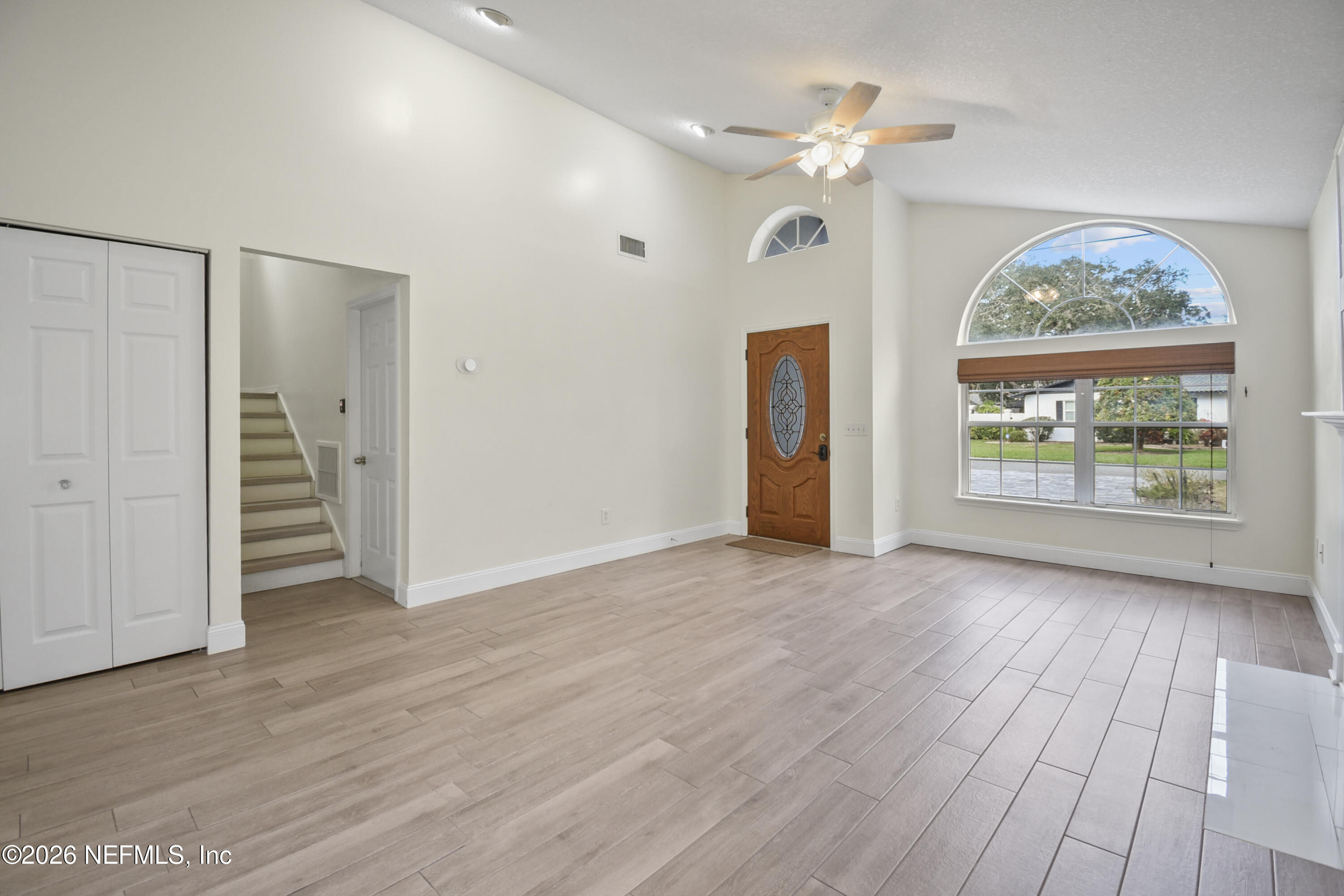 303 D Street St. Augustine Beach, FL 32080 - Photo 6 of 39 a view of an empty room with a window and wooden floor