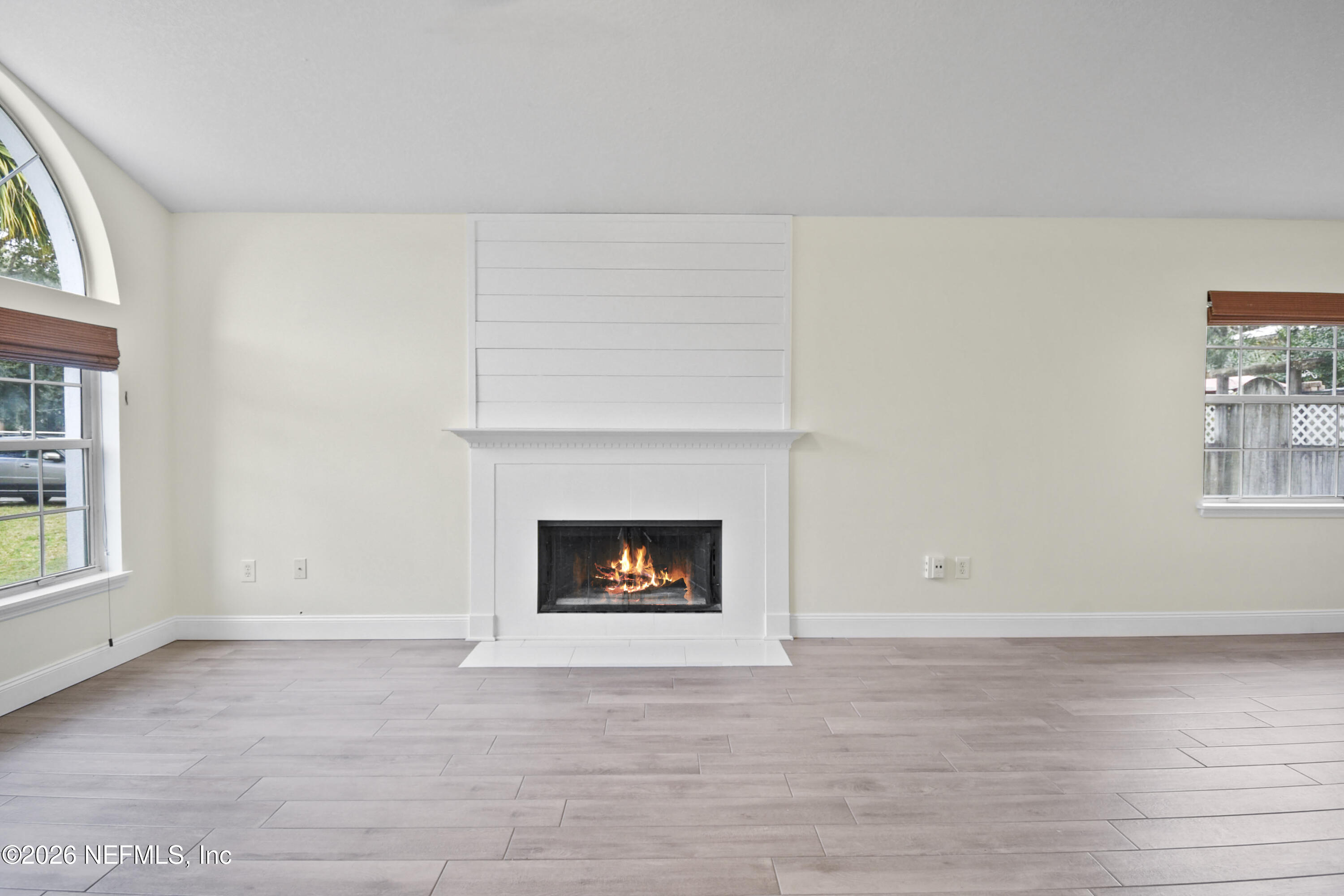 303 D Street St. Augustine Beach, FL 32080 - Photo 7 of 39 an empty room with windows and fireplace