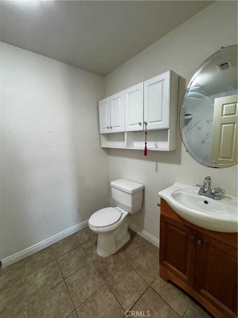 4234 Center Street Baldwin Park, CA 91706 - Photo 11 of 19 a bathroom with a toilet sink and mirror
