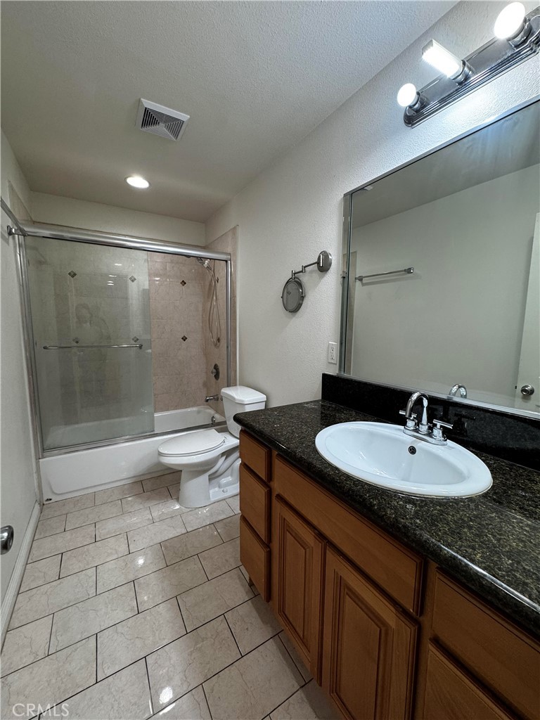 4234 Center Street Baldwin Park, CA 91706 - Photo 12 of 19 a bathroom with a sink a toilet a mirror and shower