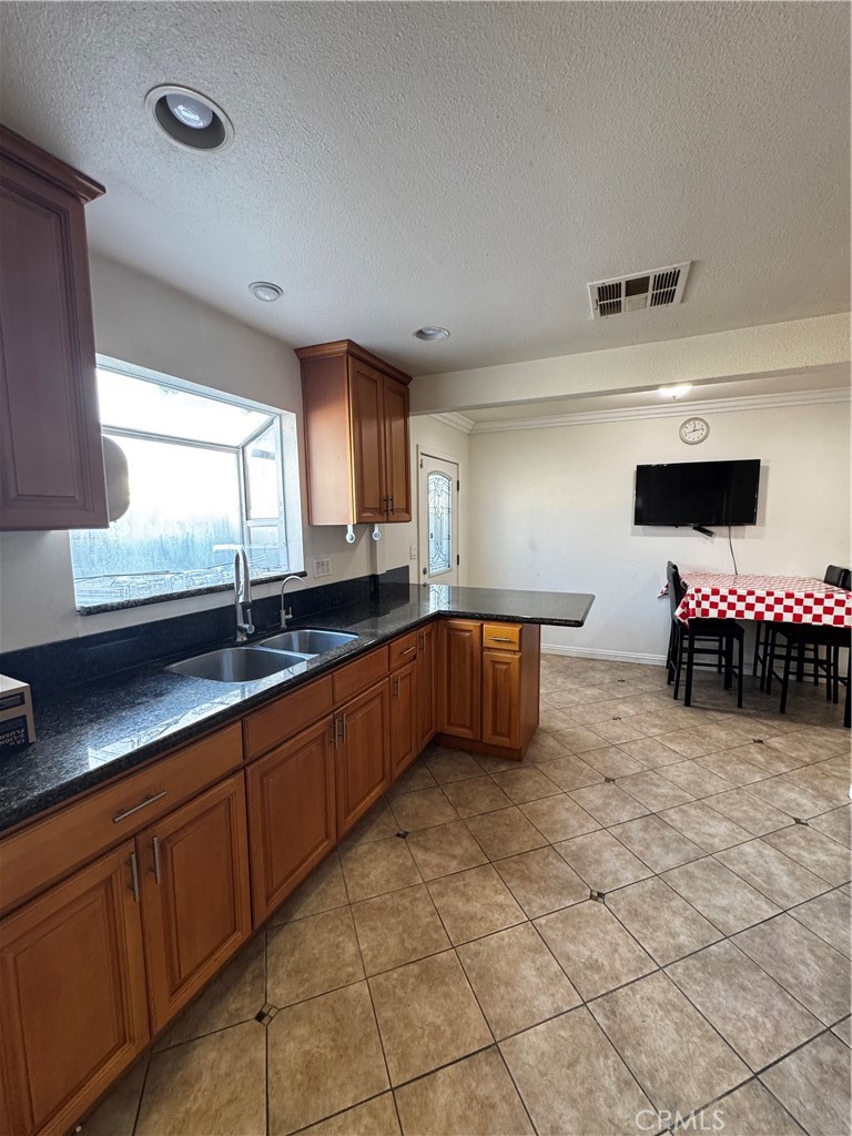 4234 Center Street Baldwin Park, CA 91706 - Photo 15 of 19 a kitchen with granite countertop a sink and a stove