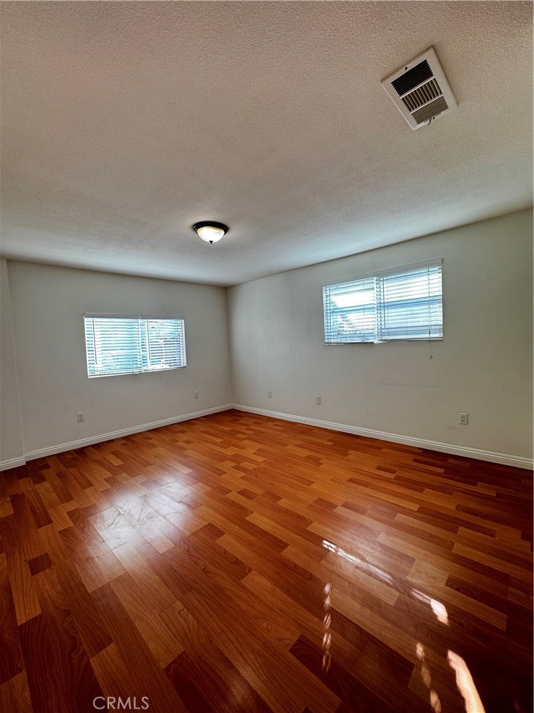 4234 Center Street Baldwin Park, CA 91706 - Photo 6 of 19 a view of empty room with wooden floor and fan