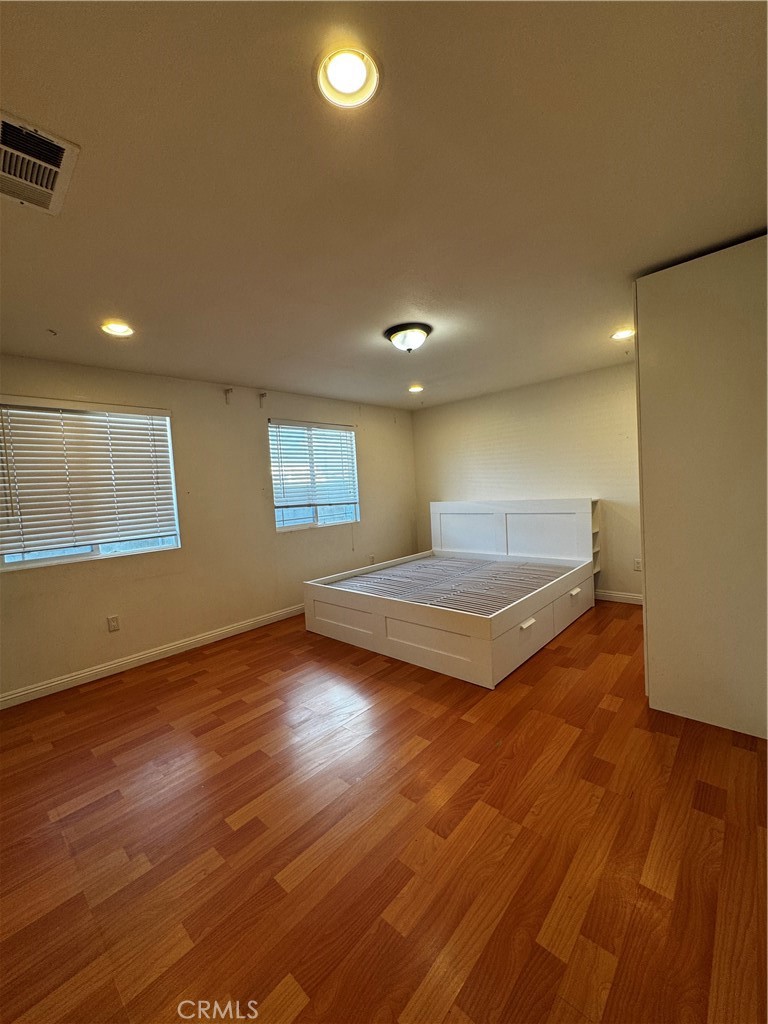 4234 Center Street Baldwin Park, CA 91706 - Photo 7 of 19 an empty room with wooden floor and windows