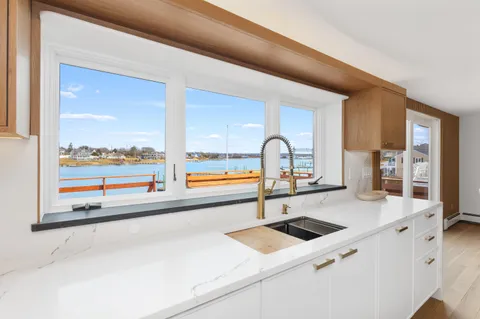 a kitchen with a large window and a sink