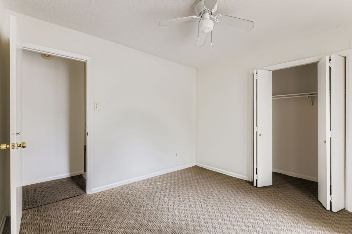 111 Stubblefield Drive Elgin, TX 78621 - Photo 17 of 27 wooden floor in an empty room with a bathroom