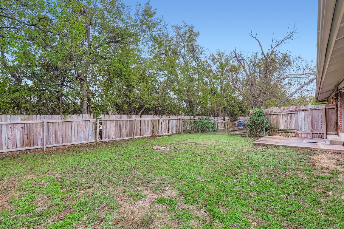 111 Stubblefield Drive Elgin, TX 78621 - Photo 24 of 27 a view of a yard with a fence and trees