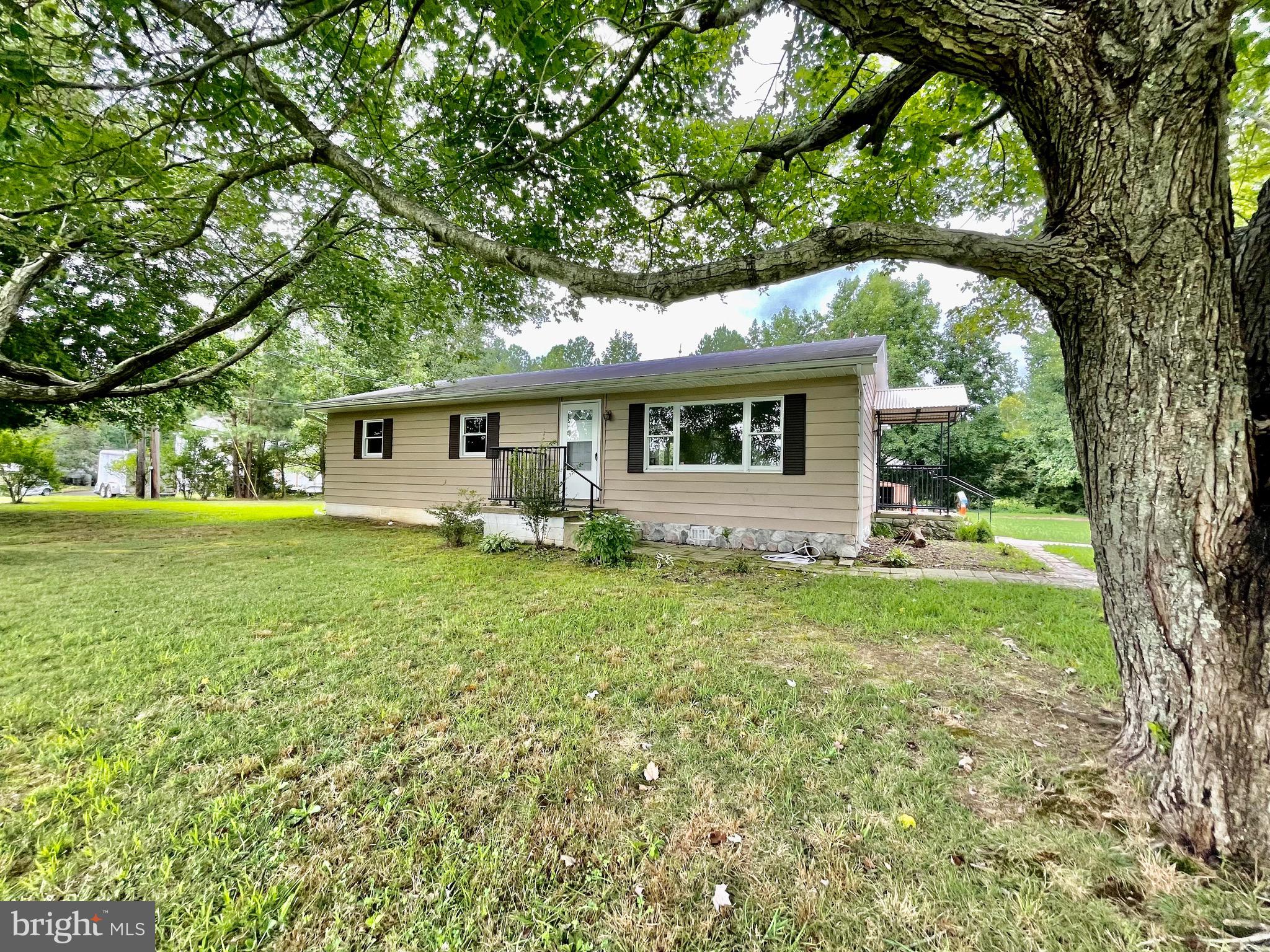 3727 Solomons Island Road St. Leonard, MD 20685 - Photo 1 of 1 a front view of a house with garden