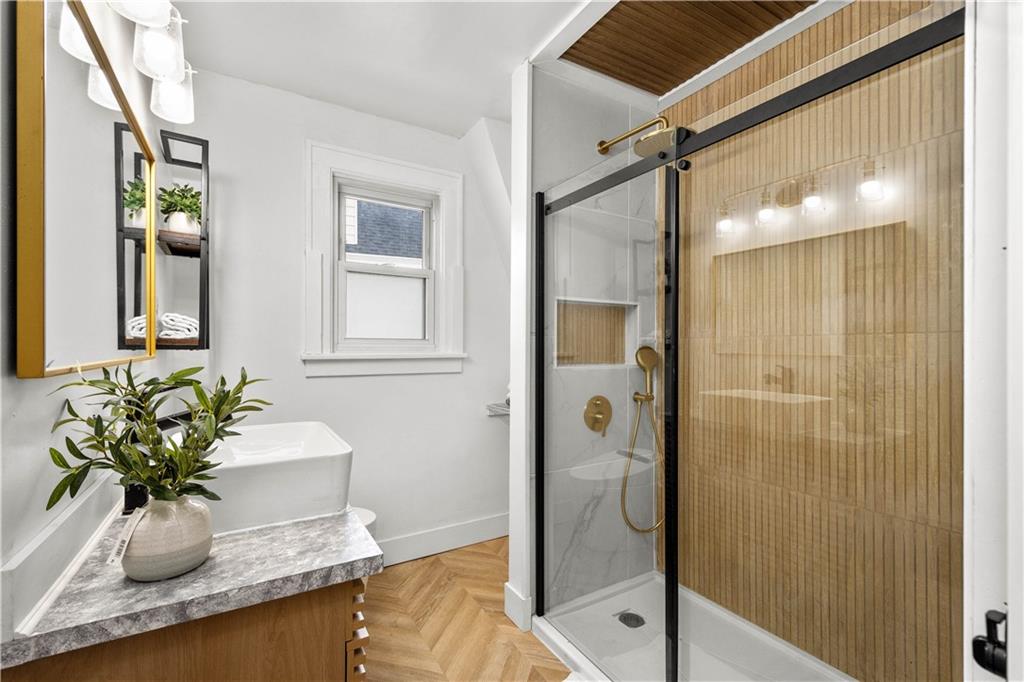 147 Carmichaels Street Rices Landing, PA 15357 - Photo 19 of 36 a bathroom with a granite countertop shower a mirror and a sink