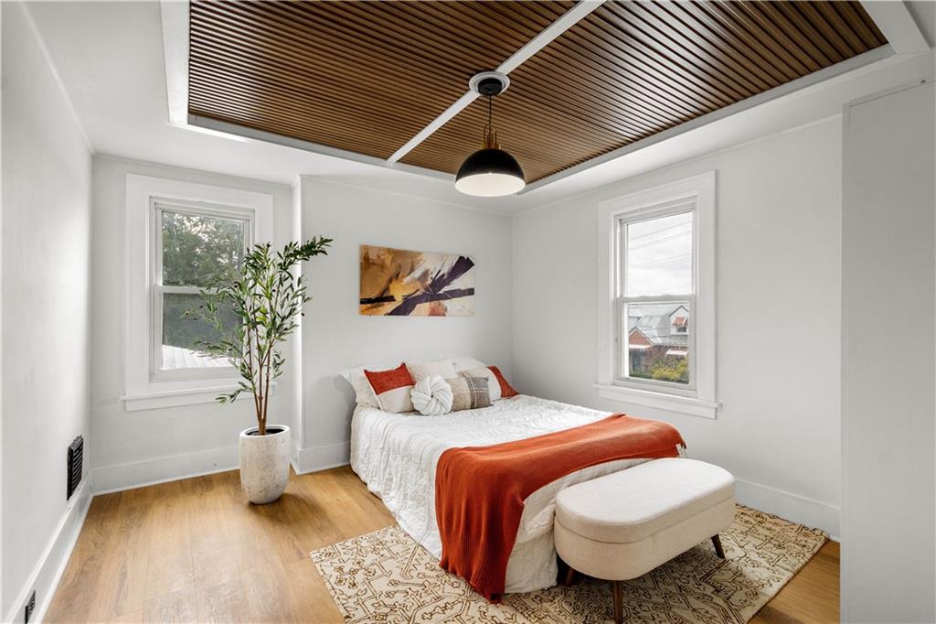 147 Carmichaels Street Rices Landing, PA 15357 - Photo 24 of 36 a bedroom with a bed and wooden floor