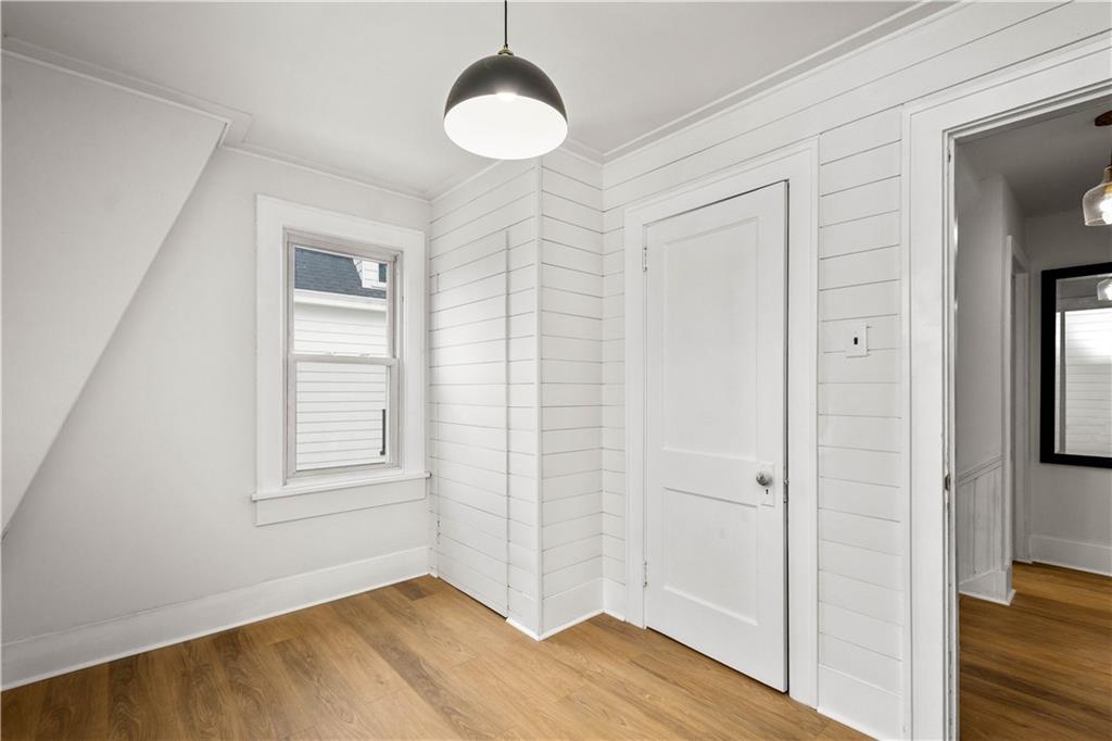 147 Carmichaels Street Rices Landing, PA 15357 - Photo 28 of 36 a view of an empty room with wooden floor and a window