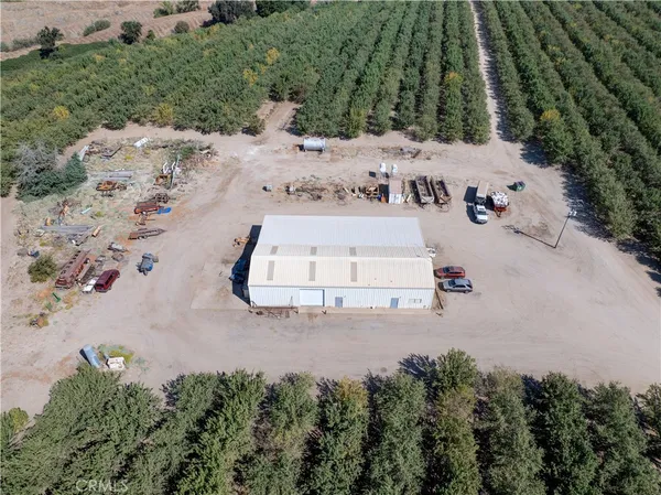 an aerial view of a house with a yard and greenery