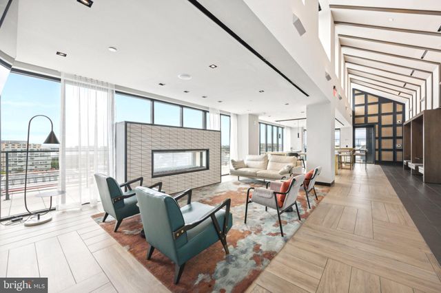 a living room with furniture a rug and a painting on the wall