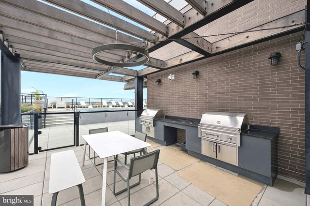 a kitchen with table chairs stainless steel appliances and cabinets