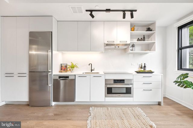 a kitchen with stainless steel appliances cabinets a refrigerator and a stove