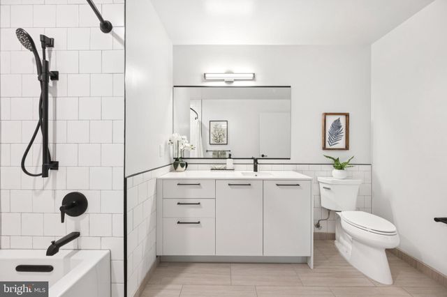 a bathroom with a sink toilet a mirror and shower