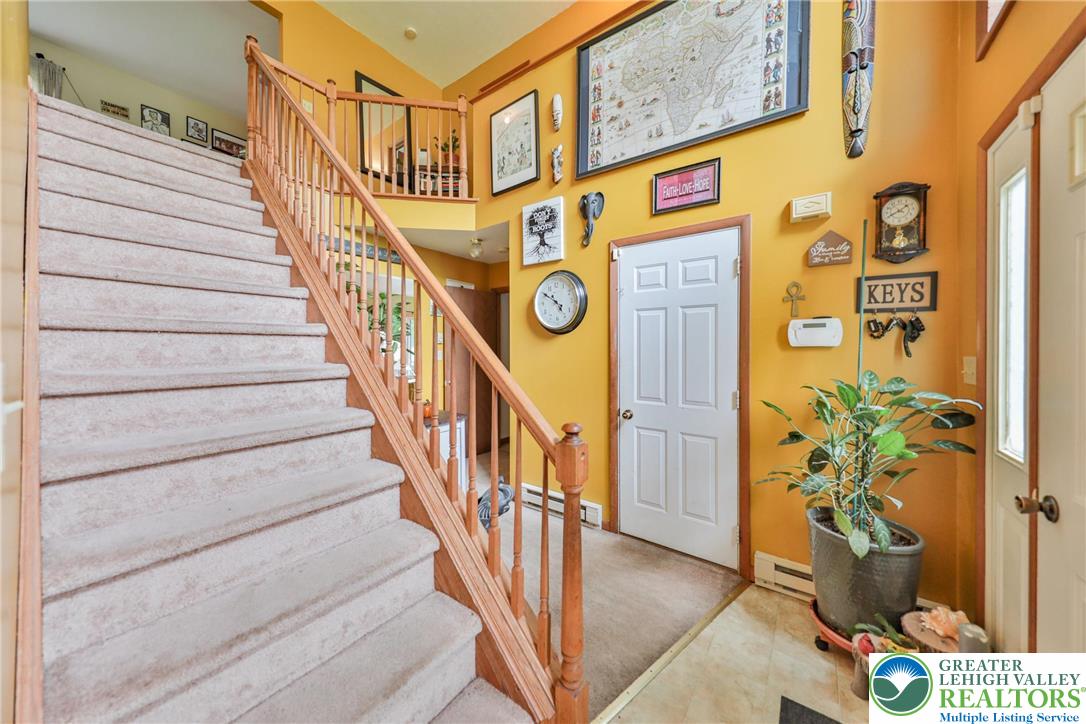 4608 Pine Ridge Drive West Bushkill, PA 18324 - Photo 45 of 62 A grand staircase ascends, complementing the soaring ceiling and inviting upper-level landing.