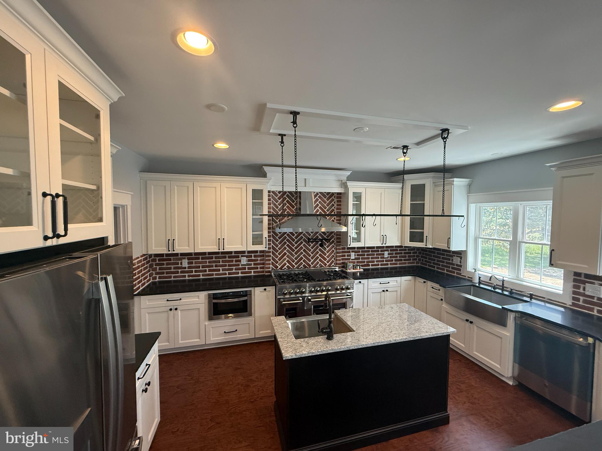 5482 Summit Bridge Road Townsend, DE 19734 - Photo 13 of 43 a kitchen with stainless steel appliances granite countertop a sink a stove and a refrigerator