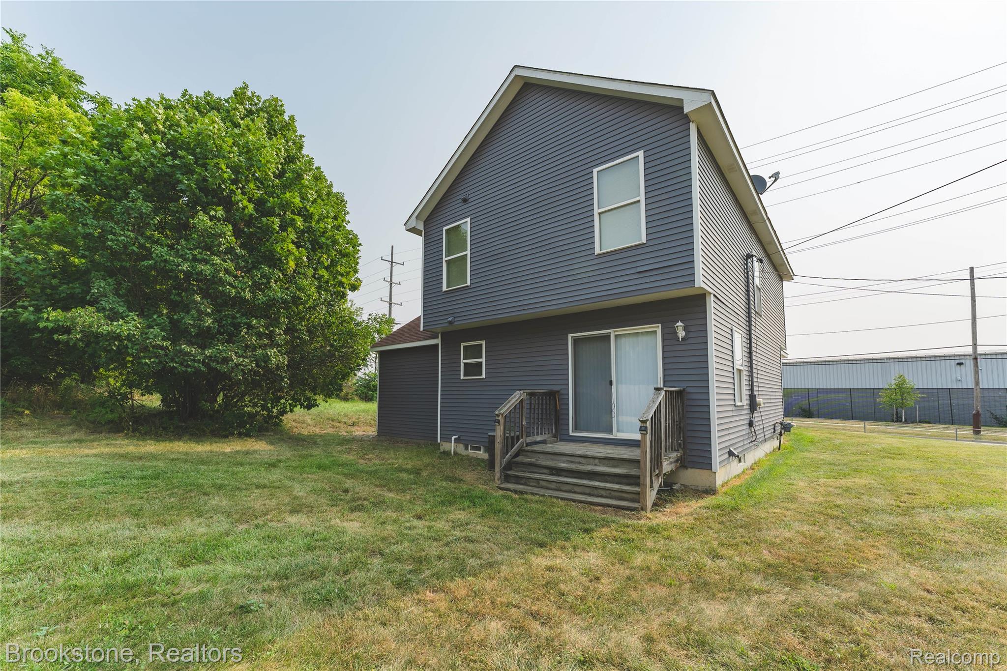 270 Franklin Road Pontiac, MI 48341 - Photo 41 of 46 Two-story exterior with dark grey horizontal siding and white trim