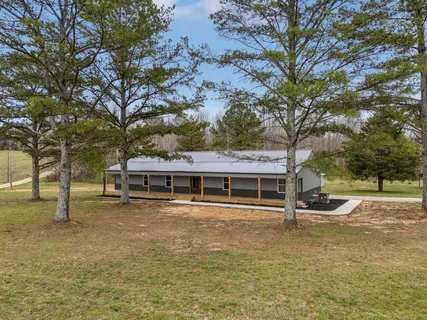 a view of a house with swimming pool and sitting area