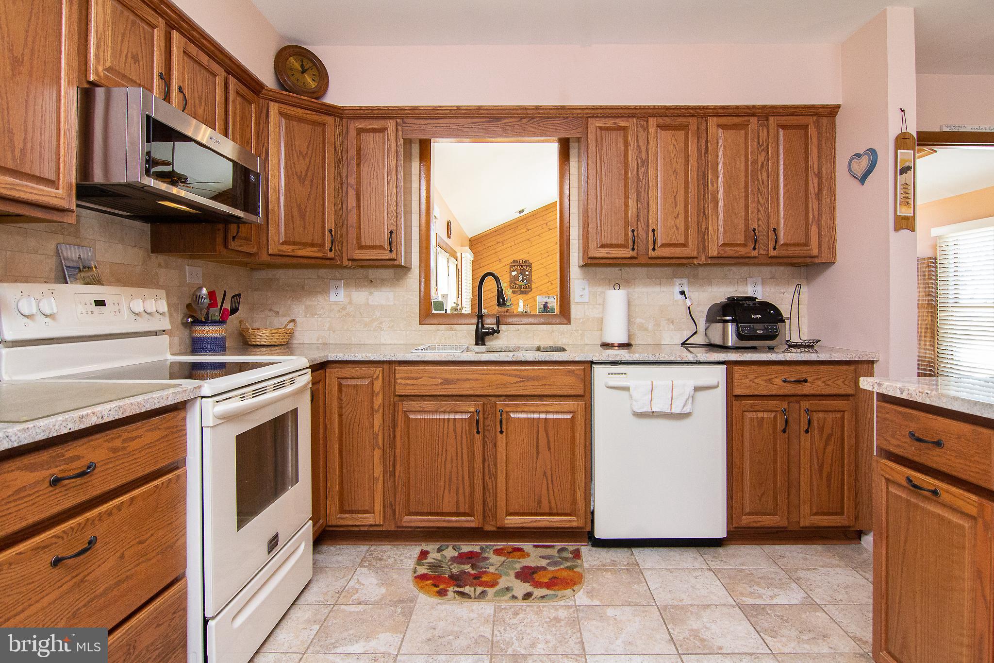 4200 Arthur Shipley Road Westminster, MD 21157 - Photo 13 of 46 a kitchen with stainless steel appliances granite countertop a sink a stove a refrigerator and cabinets