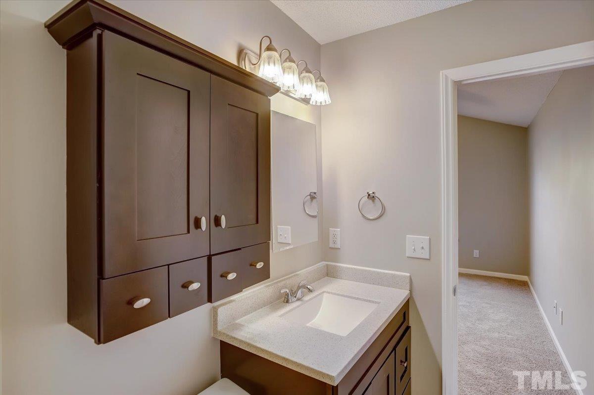 5102 Gable Ridge Drive Durham, NC 27713 - Photo 11 of 17 a bathroom with a sink a vanity and a mirror