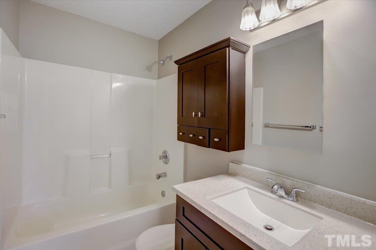 5102 Gable Ridge Drive Durham, NC 27713 - Photo 12 of 17 a bathroom with a sink a toilet and shower
