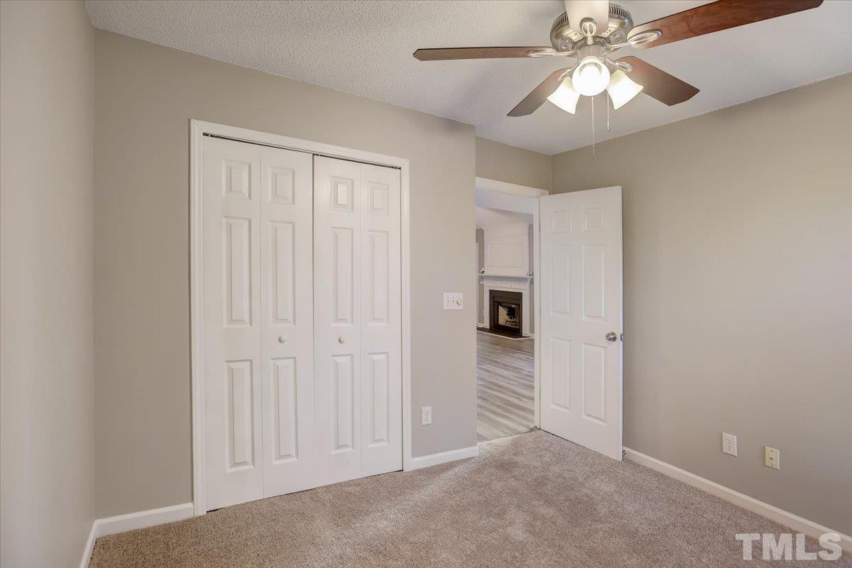 5102 Gable Ridge Drive Durham, NC 27713 - Photo 14 of 17 an empty room with a ceiling fan and a chandelier fan