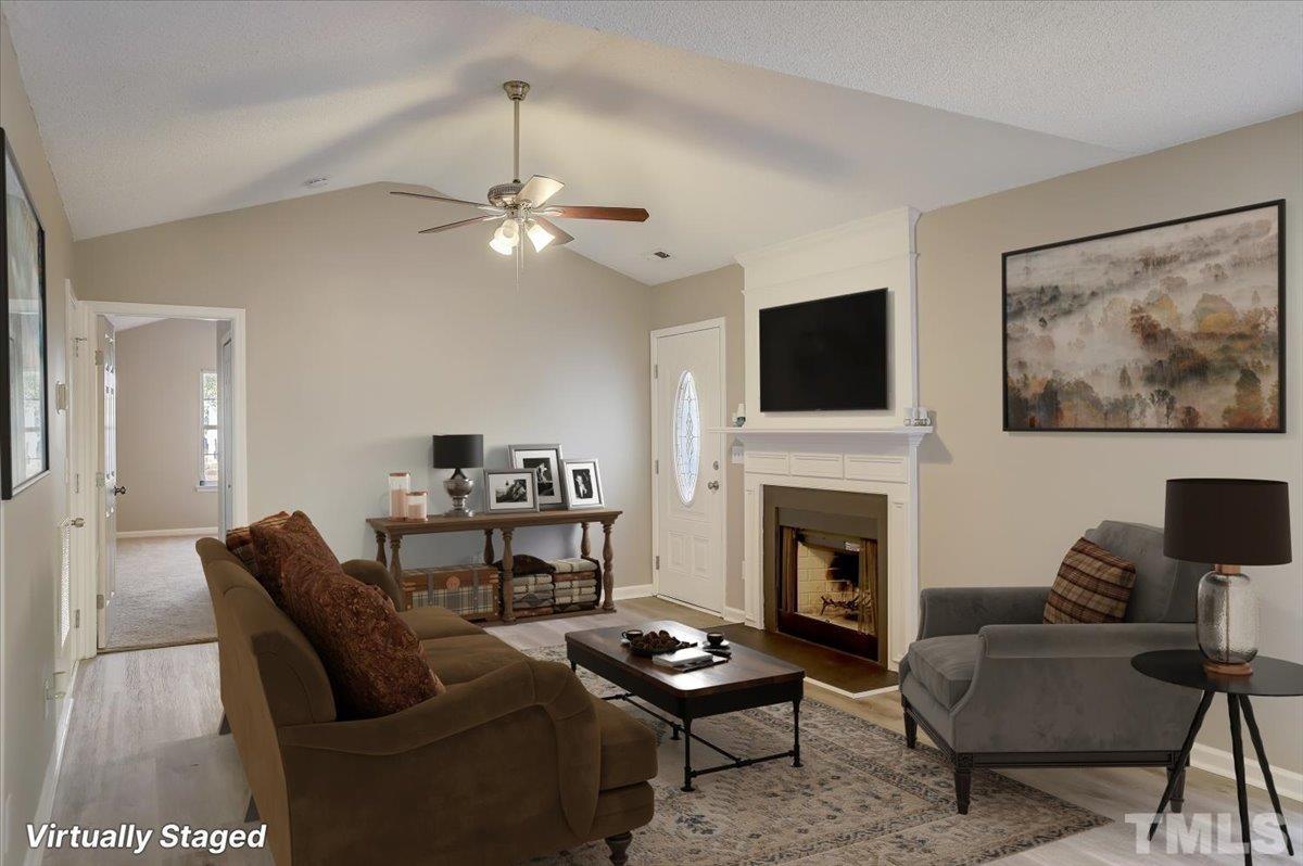 5102 Gable Ridge Drive Durham, NC 27713 - Photo 4 of 17 a living room with furniture a fireplace and a flat screen tv