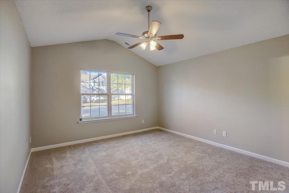 5102 Gable Ridge Drive Durham, NC 27713 - Photo 8 of 17 an empty room with a window and a fan