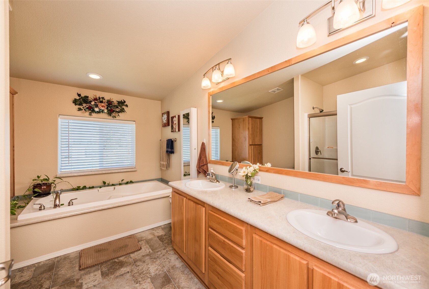 25 Michelle Lane Sequim, WA 98382 - Photo 13 of 38 a bathroom with a double vanity sink a mirror and a bathtub