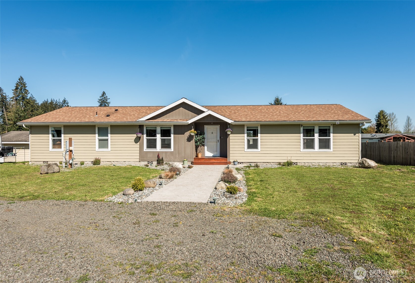 25 Michelle Lane Sequim, WA 98382 - Photo 4 of 38 a front view of a house with a garden