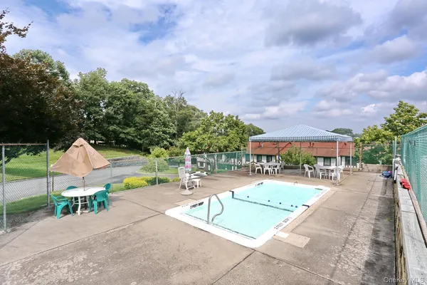 a swimming pool with outdoor seating and yard