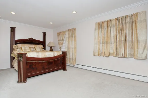 a spacious bedroom with a bed and a window