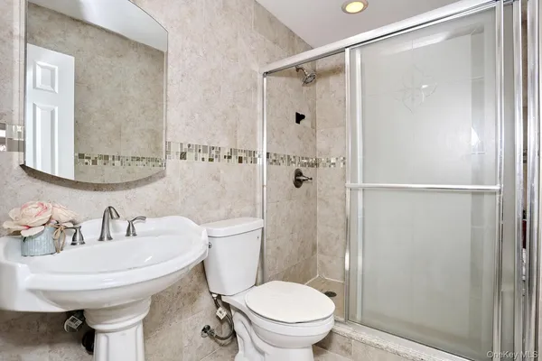 a bathroom with a sink toilet and shower