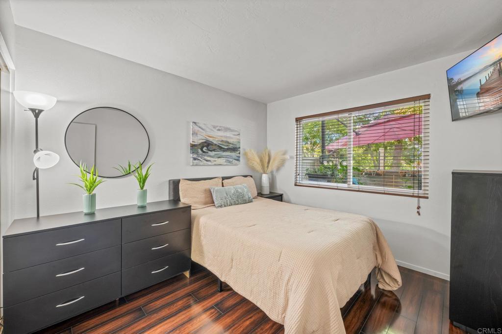 4232 Fiesta Way, Unit 3 Oceanside, CA 92057 - Photo 20 of 33 a bedroom with a bed and a dresser next to a window