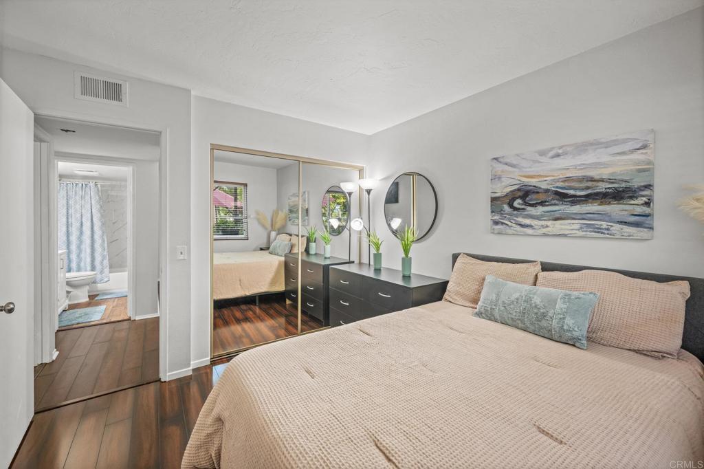 4232 Fiesta Way, Unit 3 Oceanside, CA 92057 - Photo 21 of 33 a bedroom with a bed and a chandelier