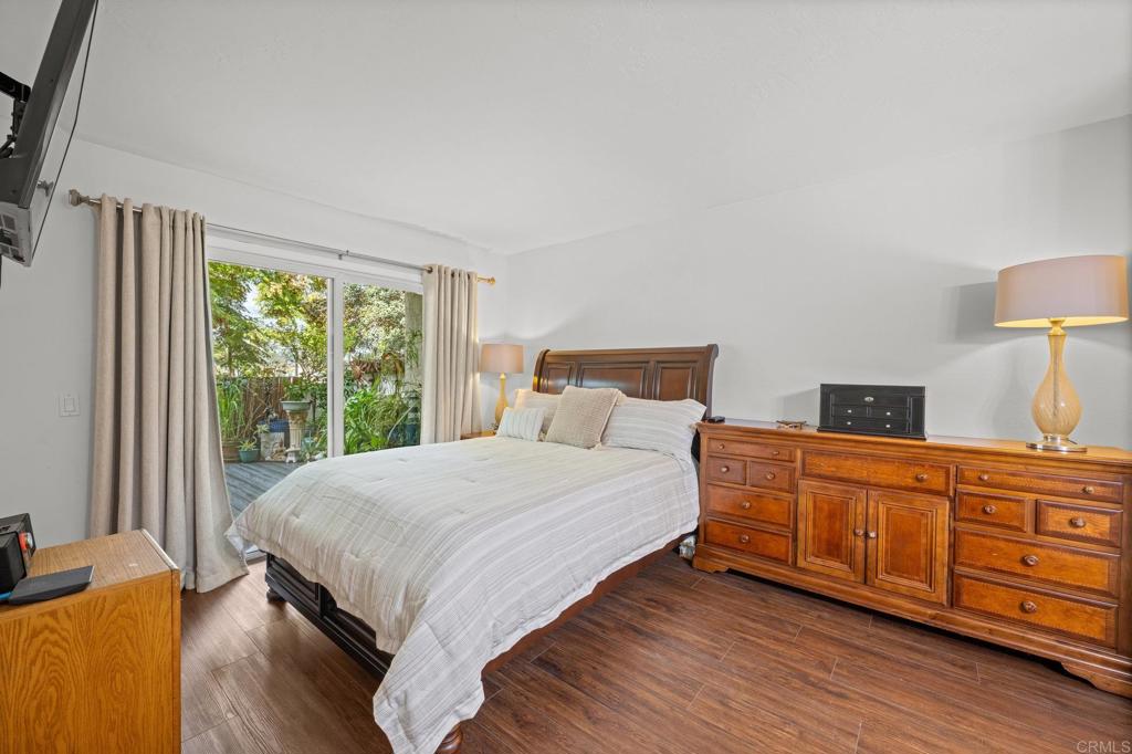 4232 Fiesta Way, Unit 3 Oceanside, CA 92057 - Photo 22 of 33 a bedroom with a bed and a dresser next to a window