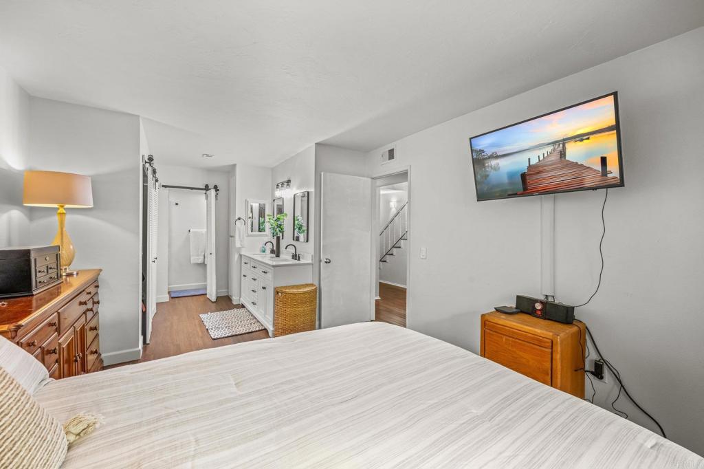 4232 Fiesta Way, Unit 3 Oceanside, CA 92057 - Photo 23 of 33 a bedroom with a bed and a flat screen tv