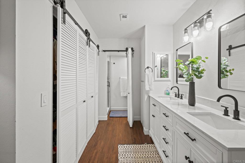 4232 Fiesta Way, Unit 3 Oceanside, CA 92057 - Photo 24 of 33 a bathroom with a double vanity sink and a mirror