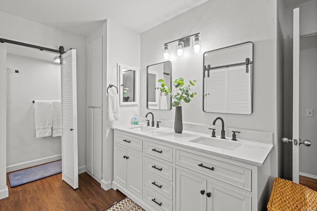 4232 Fiesta Way, Unit 3 Oceanside, CA 92057 - Photo 25 of 33 a bathroom with double vanity sink a two mirror a window and a shower