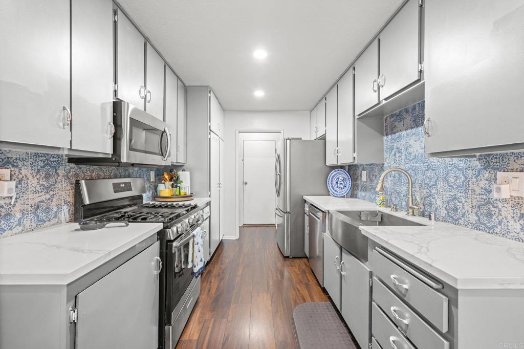4232 Fiesta Way, Unit 3 Oceanside, CA 92057 - Photo 8 of 33 a kitchen with stainless steel appliances granite countertop a sink stove and refrigerator
