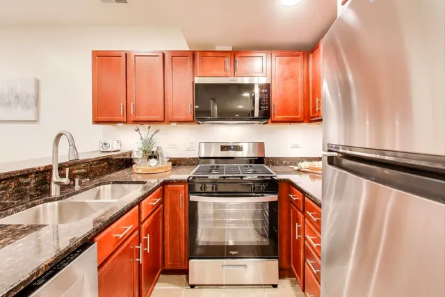 a kitchen with a sink stove top oven and cabinets