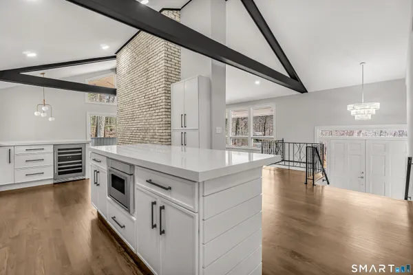a kitchen with stainless steel appliances granite countertop a stove and a wooden floors
