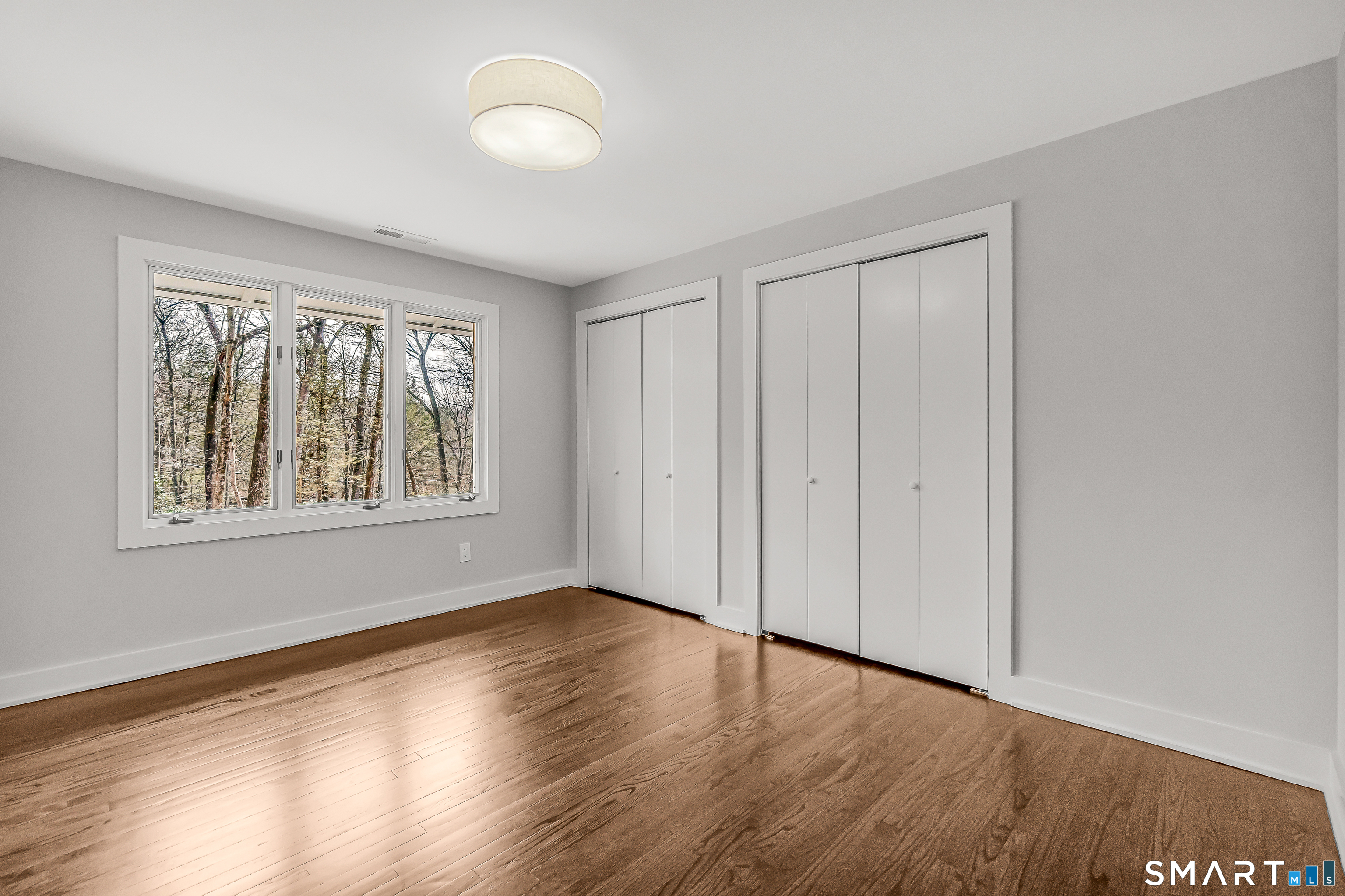 73 Buck Hill Road Easton, CT 06612 - Photo 23 of 44 a view of an empty room with wooden floor and a window