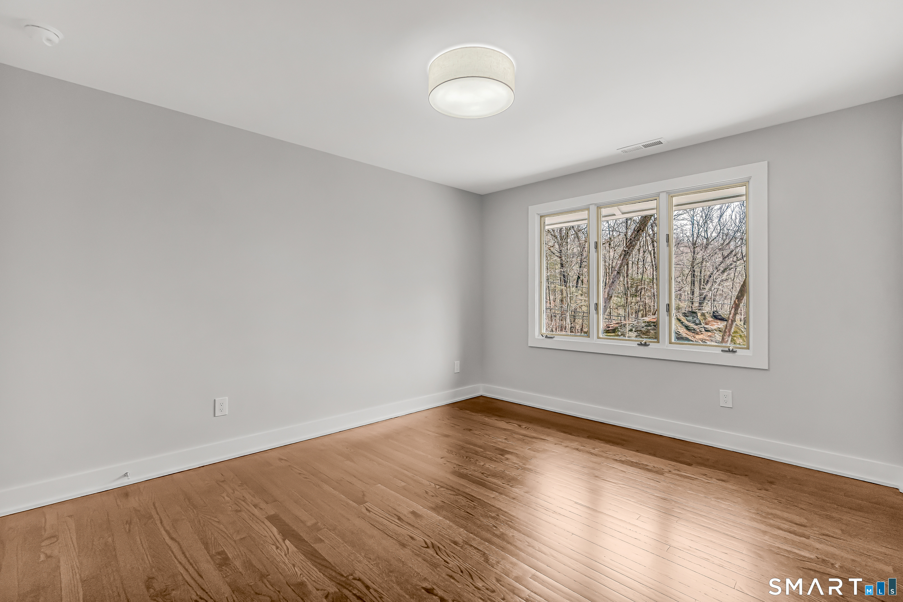 73 Buck Hill Road Easton, CT 06612 - Photo 24 of 44 a view of an empty room with wooden floor and a window