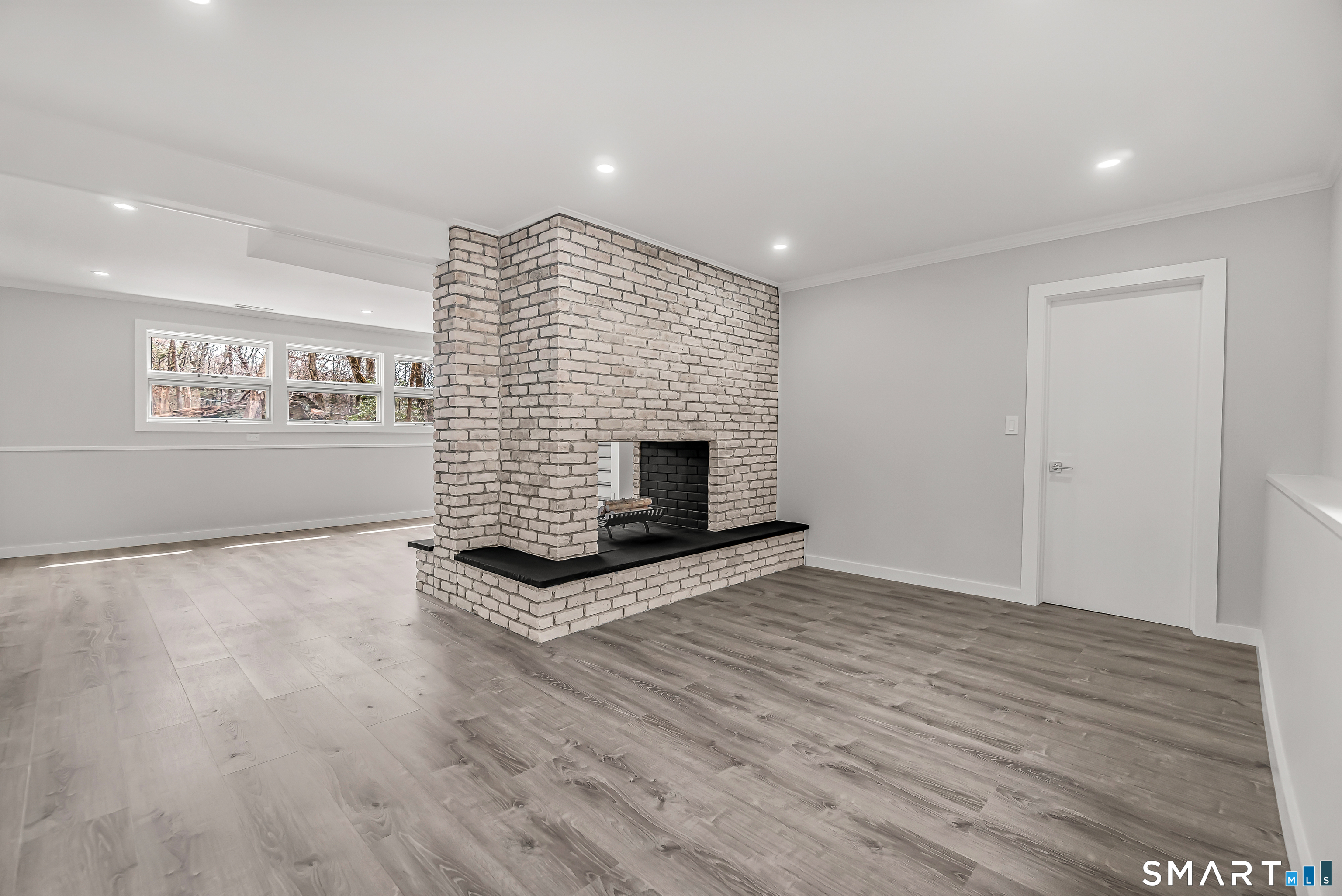 73 Buck Hill Road Easton, CT 06612 - Photo 30 of 44 a view of empty room with wooden floor and fireplace