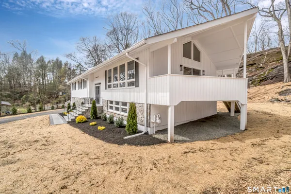 a view of a house with a wooden fence