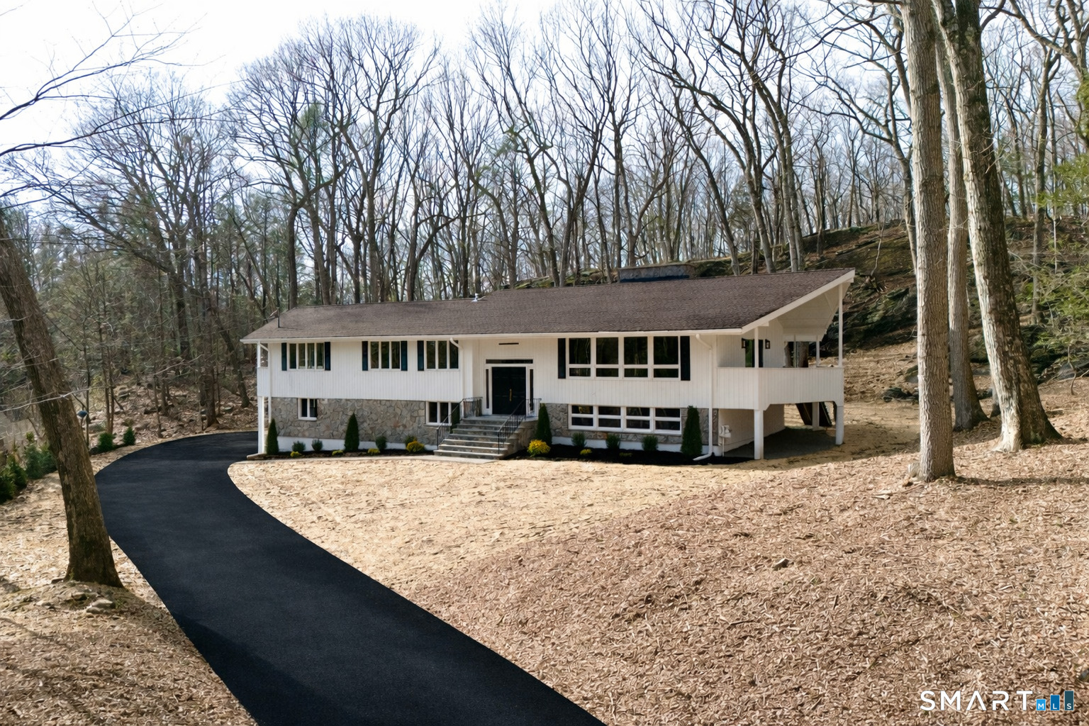 73 Buck Hill Road Easton, CT 06612 - Photo 41 of 44 front view of a house with a yard covered in snow