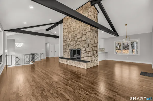a living room with fireplace furniture and a wooden floor