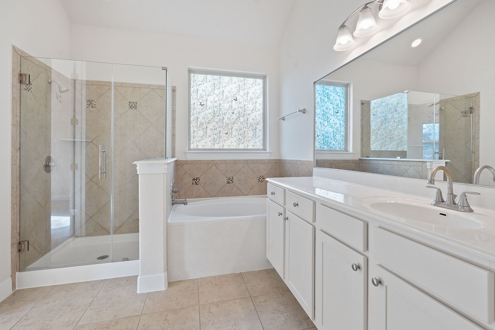 21100 Windmill Ranch Avenue Pflugerville, TX 78660 - Photo 13 of 29 Full bathroom with a stall shower, vanity, a garden tub, and light tile patterned floors